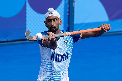 India's Mandeep Singh controls the ball